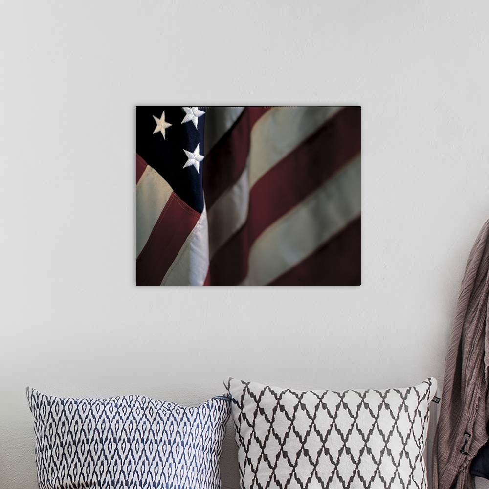 A bohemian room featuring Oversized, close up landscape photograph of part of the stars and stripes of the American flag.