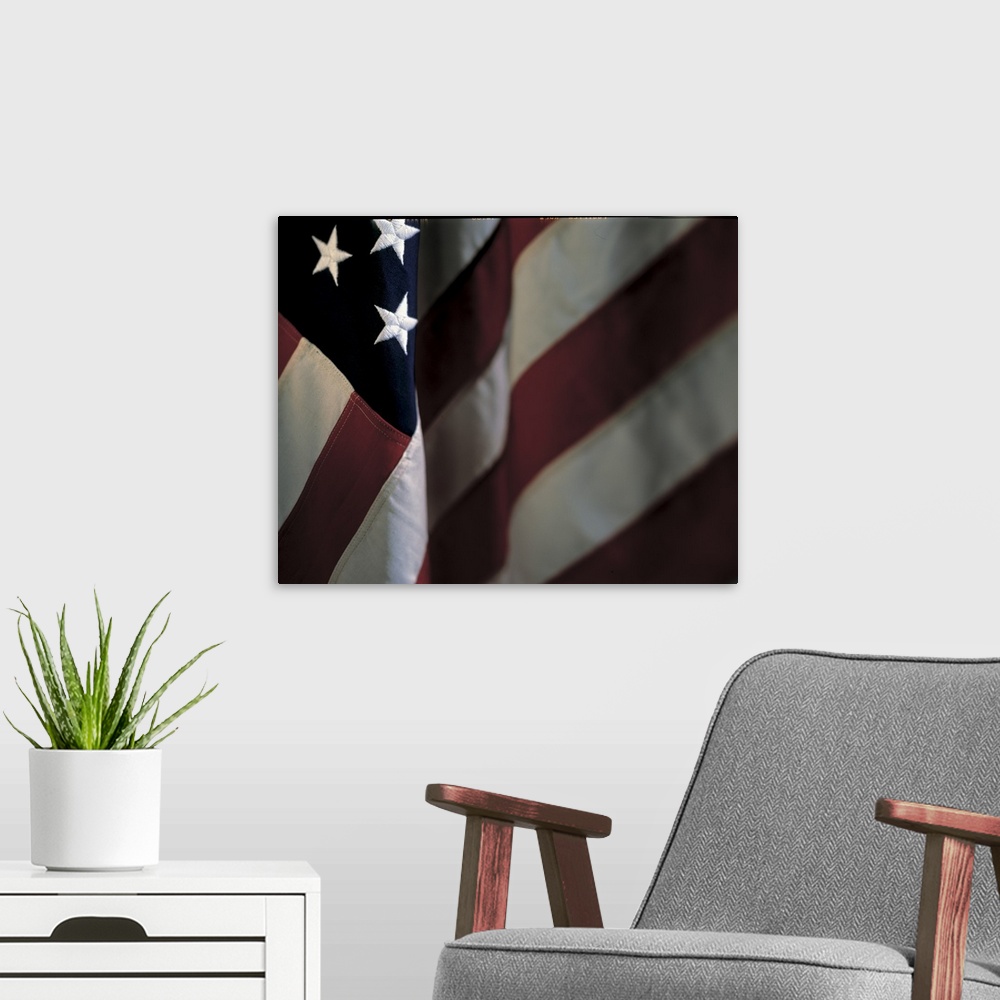 A modern room featuring Oversized, close up landscape photograph of part of the stars and stripes of the American flag.