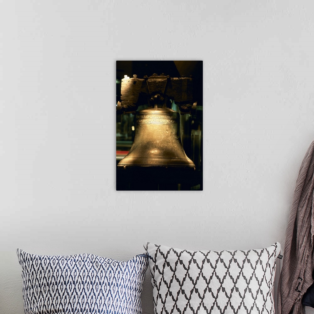 A bohemian room featuring A large close up photograph of the liberty bell with a touch of sunlight hitting it.