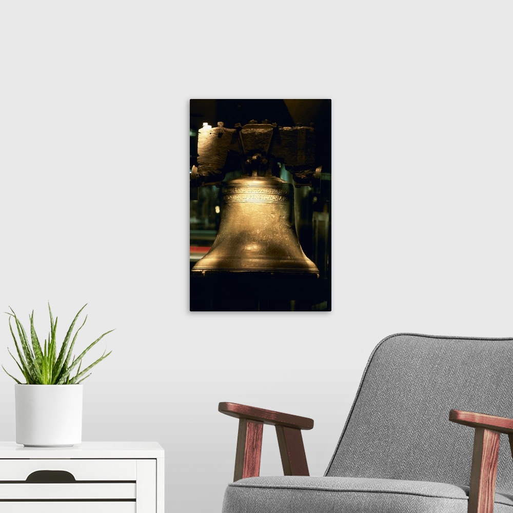 A modern room featuring A large close up photograph of the liberty bell with a touch of sunlight hitting it.