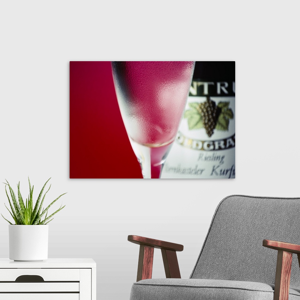 A modern room featuring Close-up of a glass of red wine and a wine bottle