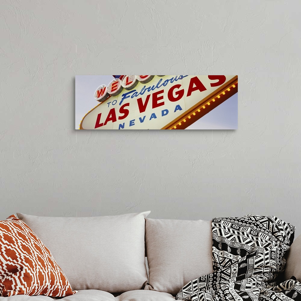 A bohemian room featuring Panoramic photo of a close up of the classic Las Vegas sign.