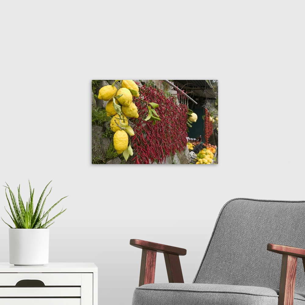 A modern room featuring Lemons and chili peppers in Italy hang for sale in a local farmers market.