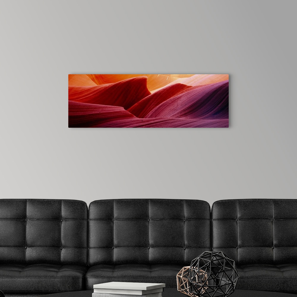 A modern room featuring Panoramic photograph of eroded rock in Antelope Canyon, with light forming wavy patters as it bou...