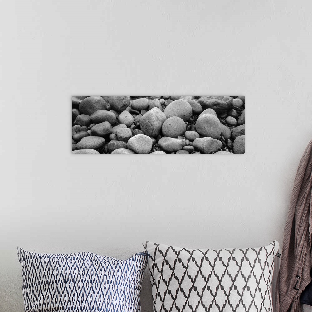 A bohemian room featuring Panoramic canvas zoomed in on round and smooth rocks.