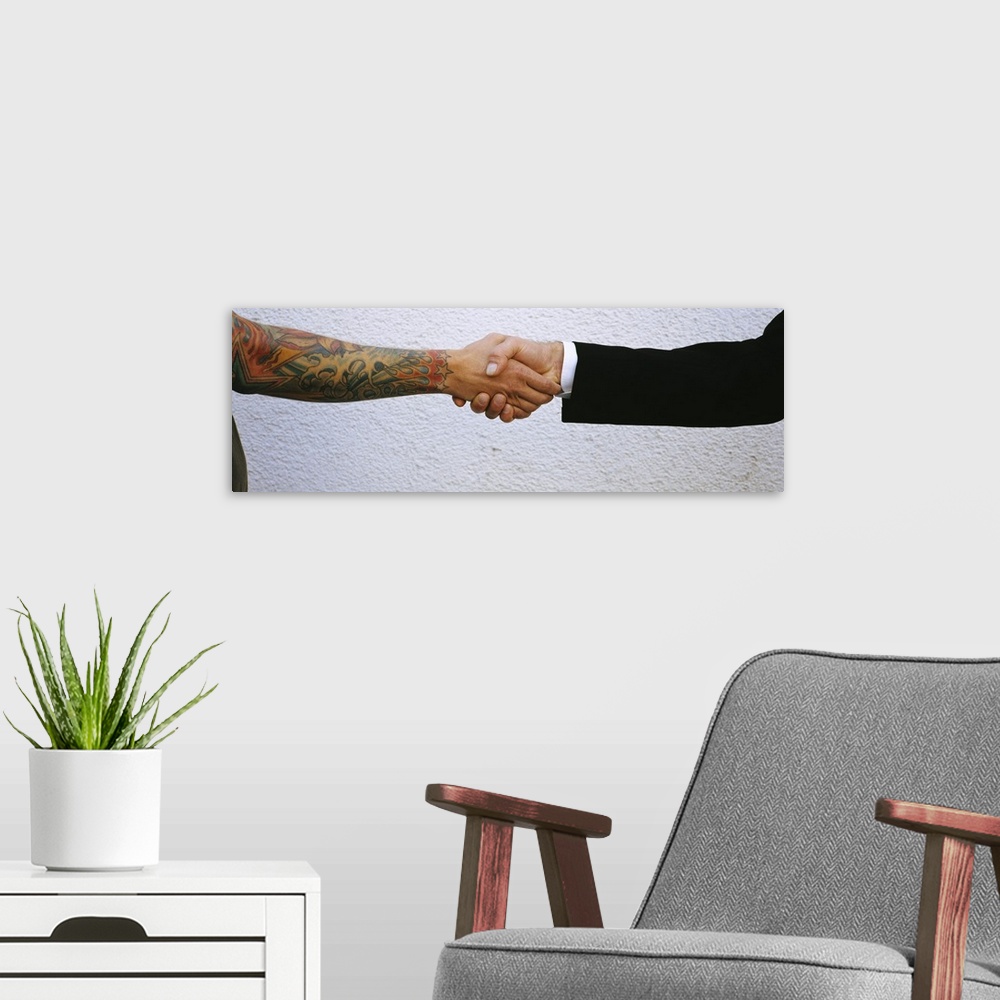 A modern room featuring Man shaking hands with tatooed man, Germany