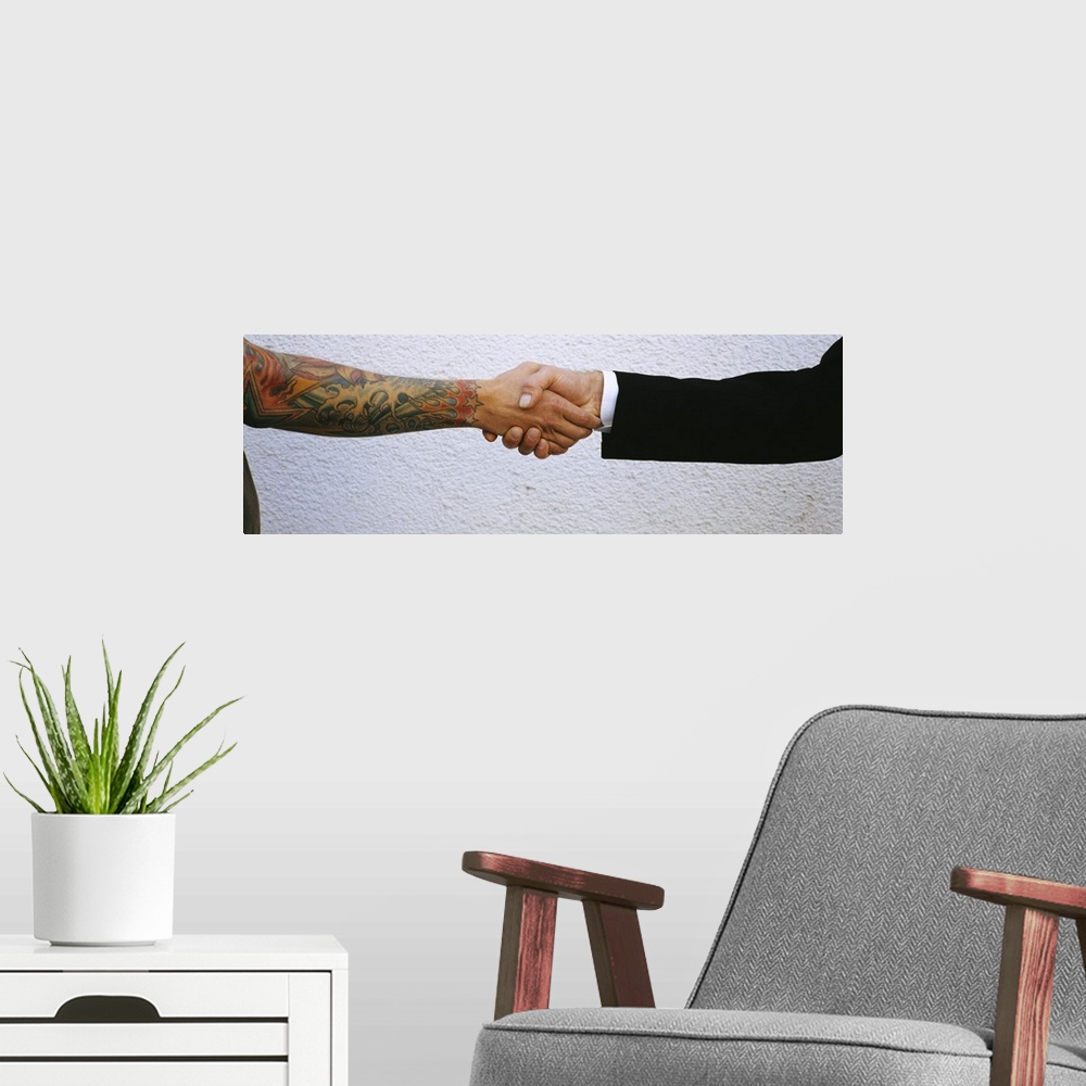 A modern room featuring Man shaking hands with tatooed man, Germany