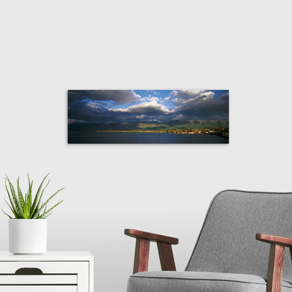 A modern room featuring Clouded sky over a lake, Flathead Lake, Swan Range, Polson, Montana