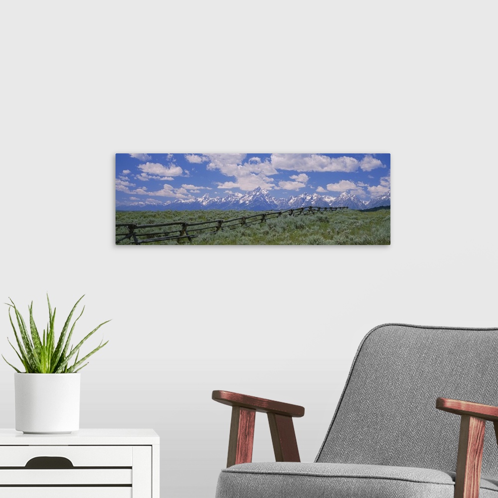 A modern room featuring Clouded sky over snow covered mountains, Grand Teton, Grand Teton National Park, Wyoming