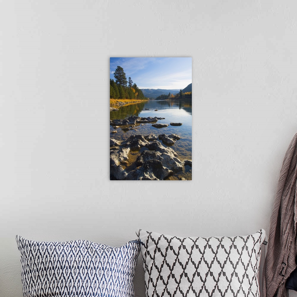 A bohemian room featuring Clouds and distant mountains reflected in rocky Kootenai River, Montana