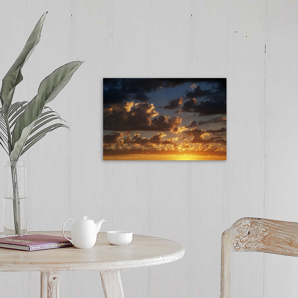 A farmhouse room featuring Horizontal photograph on a large canvas of a vibrant, golden sunset beneath a darkening sky full ...