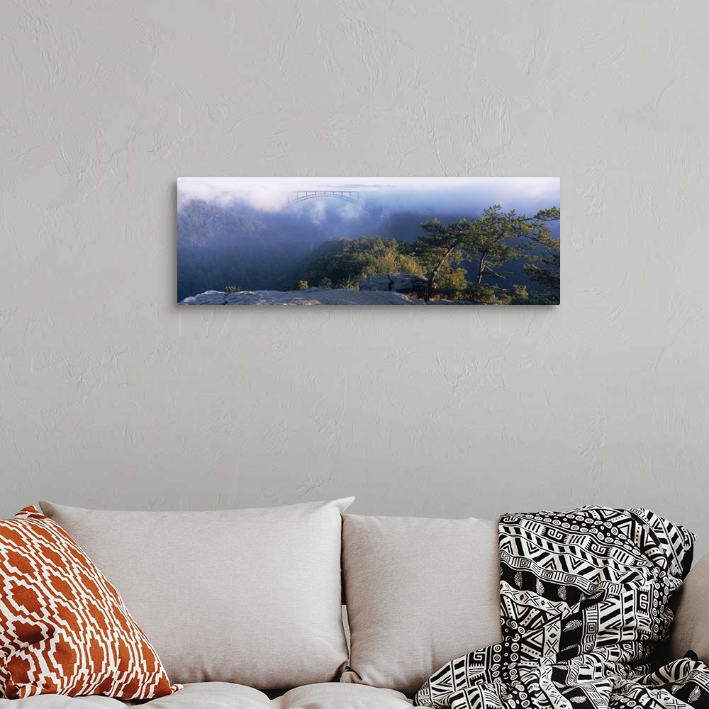 A bohemian room featuring Panoramic image of the new River Gorge Bridge peeking through the fog high above the New River an...