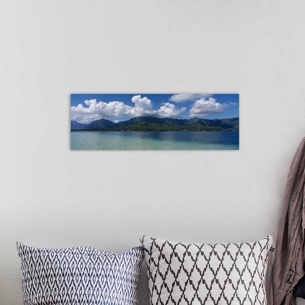 A bohemian room featuring Panoramic photograph taken across the ocean looking at a Hawaiian island with immense clouds floa...