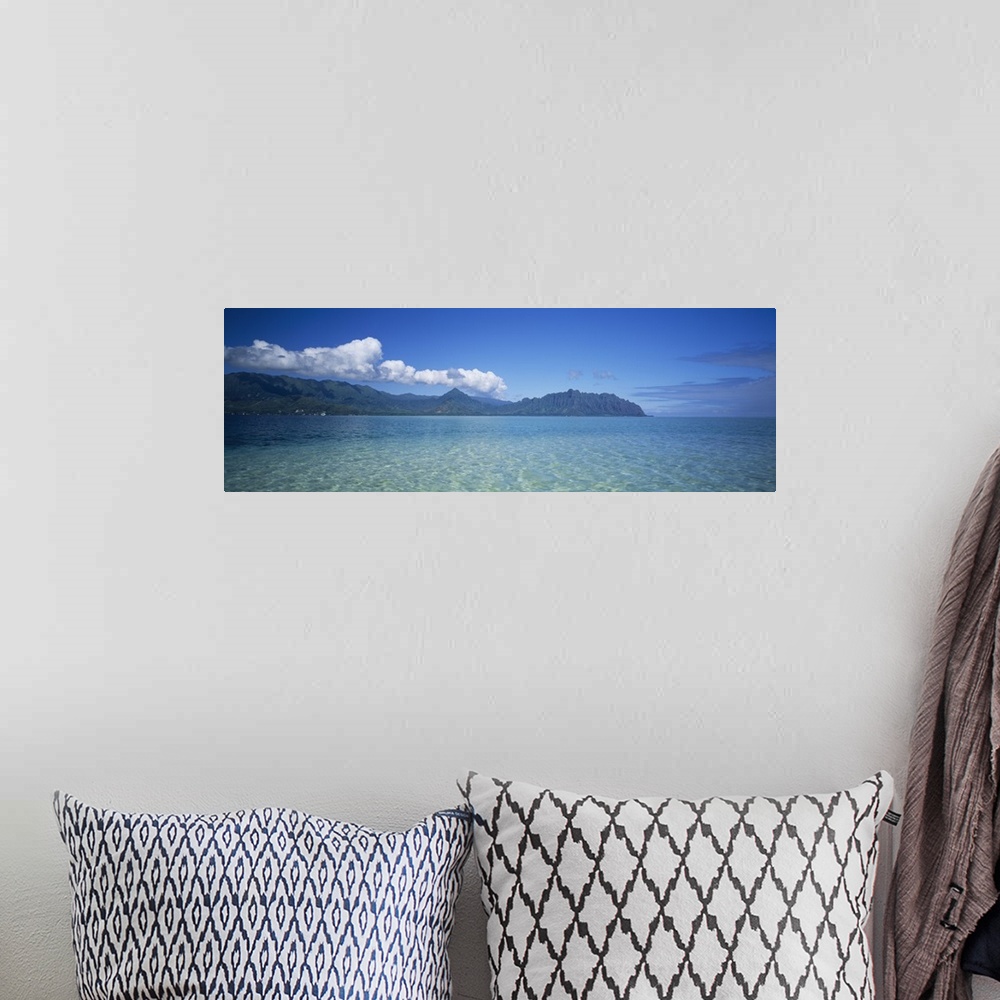 A bohemian room featuring Panoramic view of the tropical ocean surface of the Pacific, with tall mountains and clouds on th...
