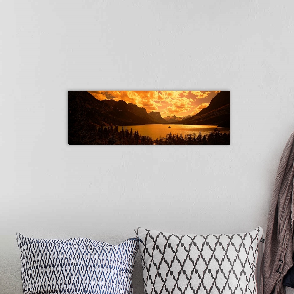 A bohemian room featuring This landscape photograph shows sunlight shining through cloud cover on to a lake created in the ...