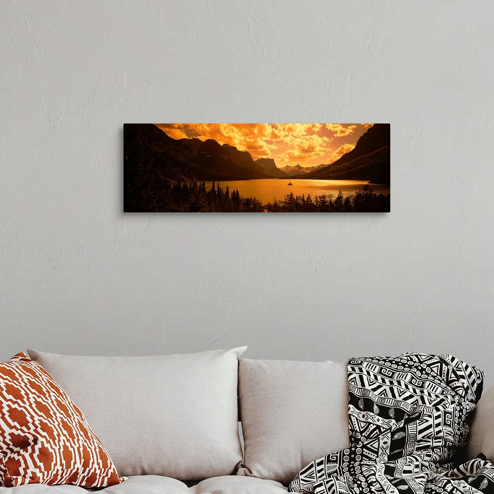 A bohemian room featuring This landscape photograph shows sunlight shining through cloud cover on to a lake created in the ...