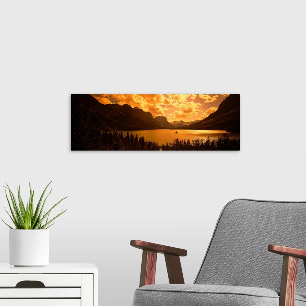 A modern room featuring This landscape photograph shows sunlight shining through cloud cover on to a lake created in the ...