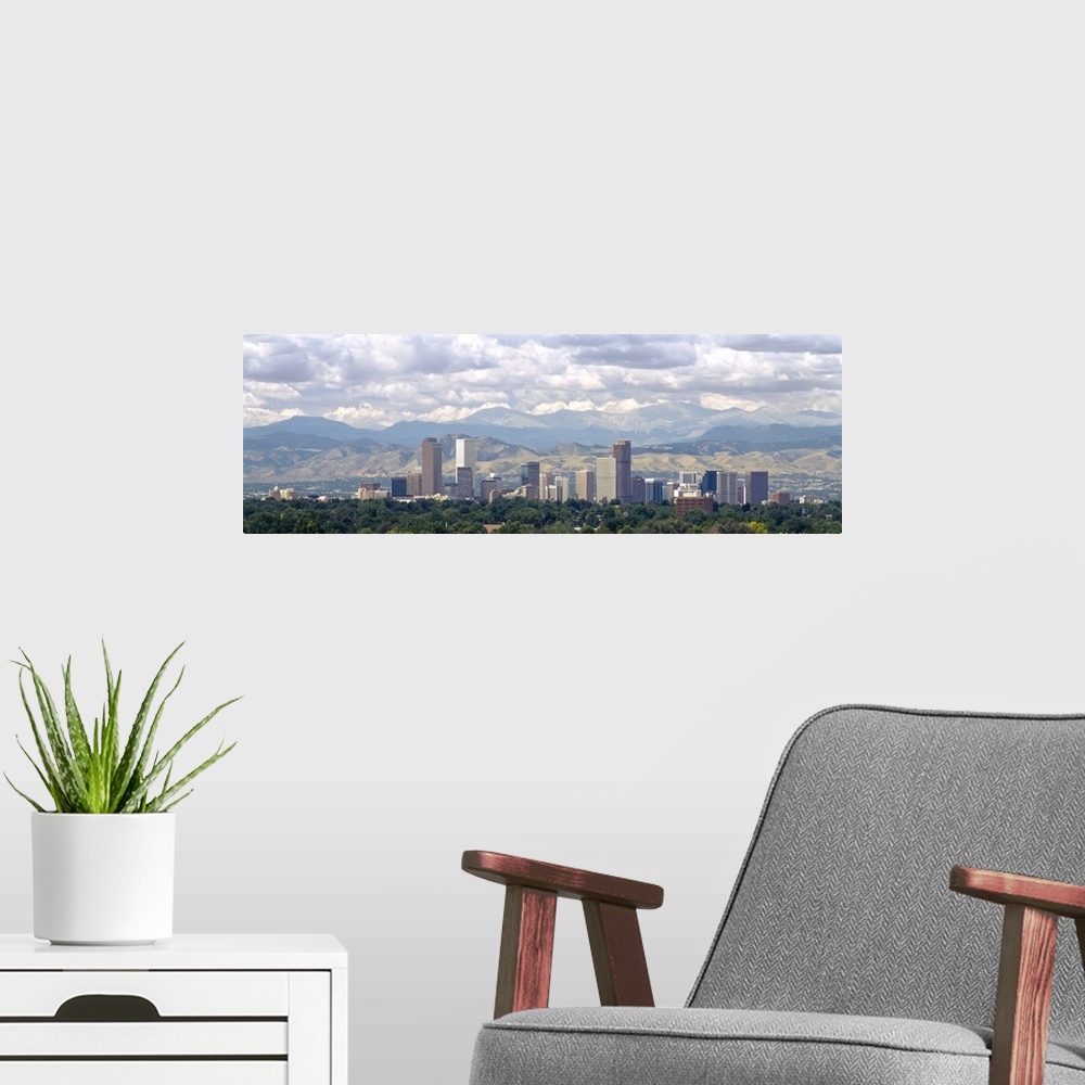 A modern room featuring Panoramic photograph shows a line of skyscrapers in a capital city within the Midwestern United S...