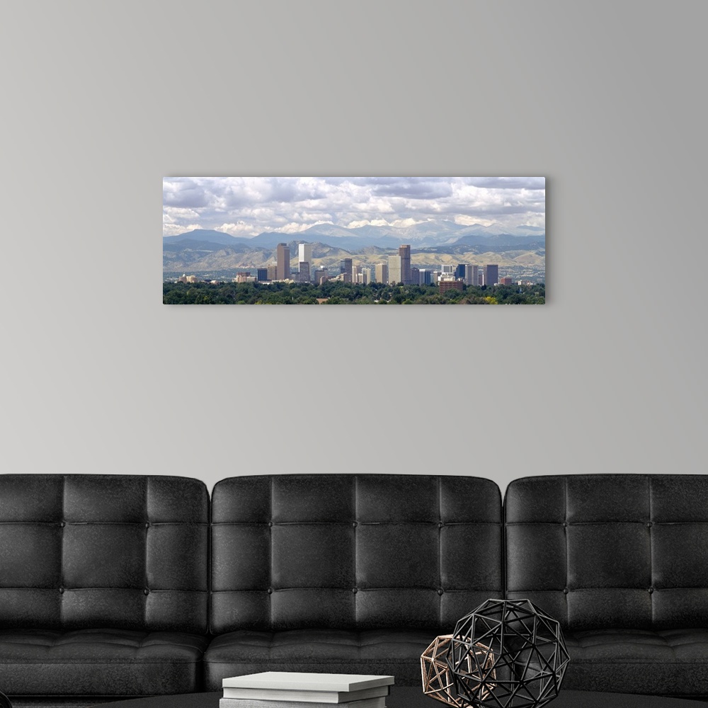 A modern room featuring Panoramic photograph shows a line of skyscrapers in a capital city within the Midwestern United S...