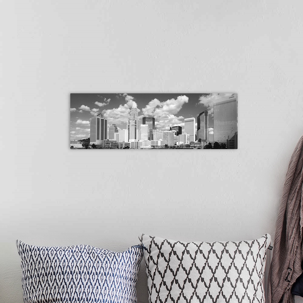 A bohemian room featuring Black and white photograph of the city skyline of Charlotte, North Carolina.