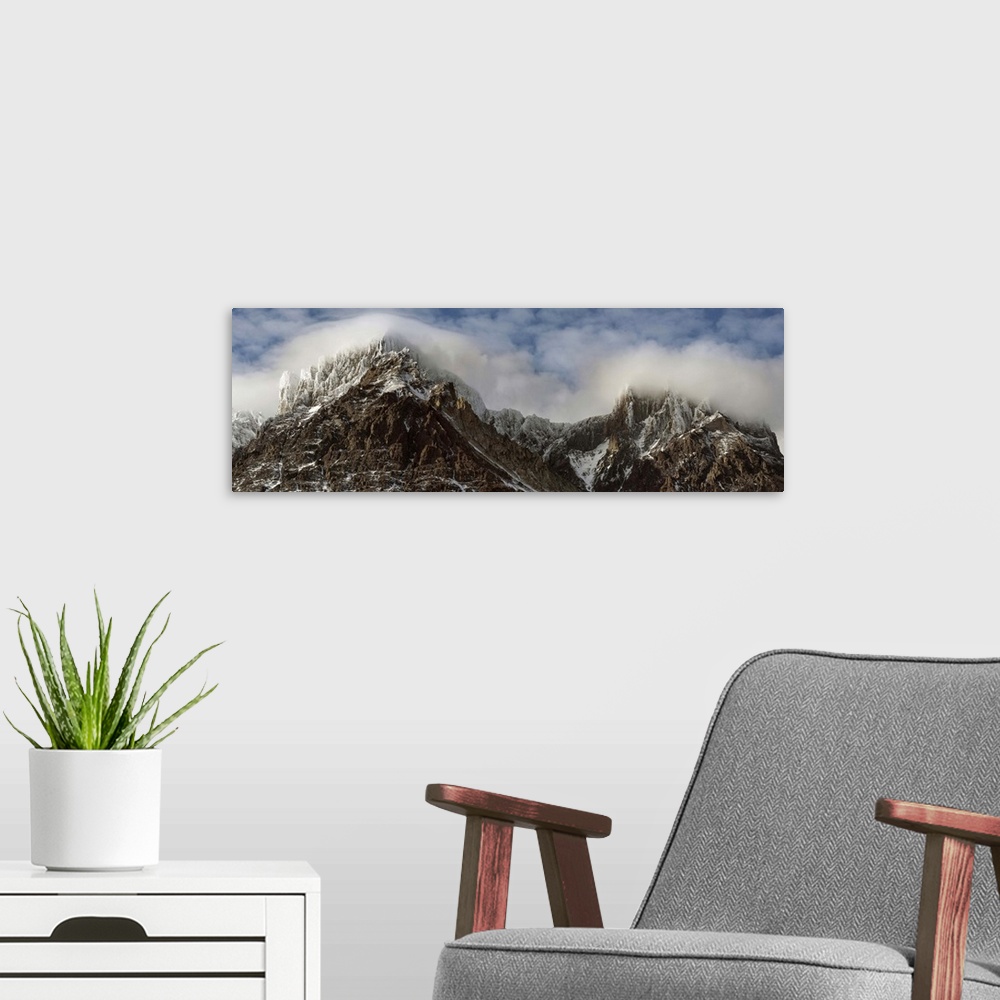 A modern room featuring Clouds over Snowcapped mountain range, Magallanes Region, Patagonia, Chile