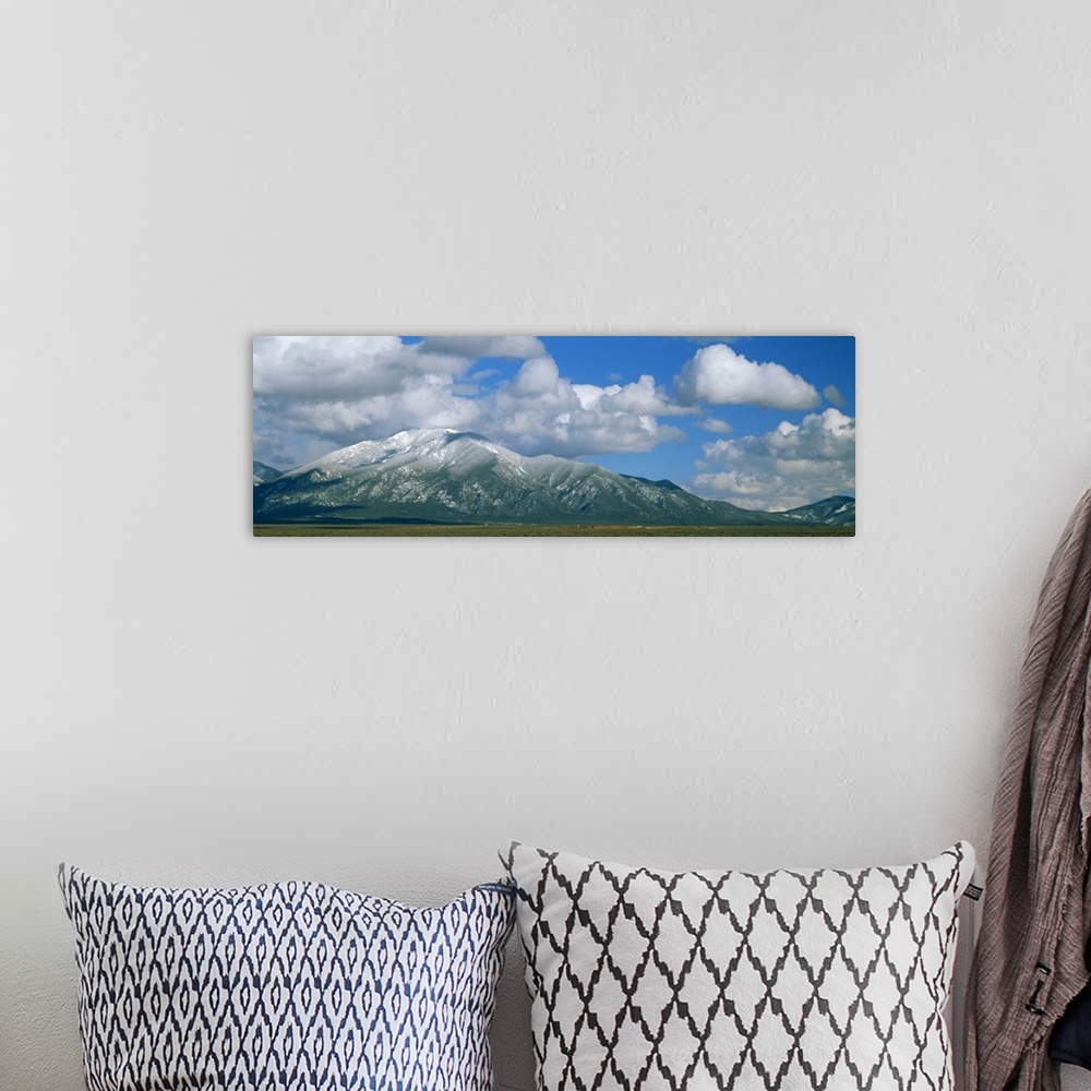 A bohemian room featuring Clouds over snowcapped mountains, Taos, New Mexico