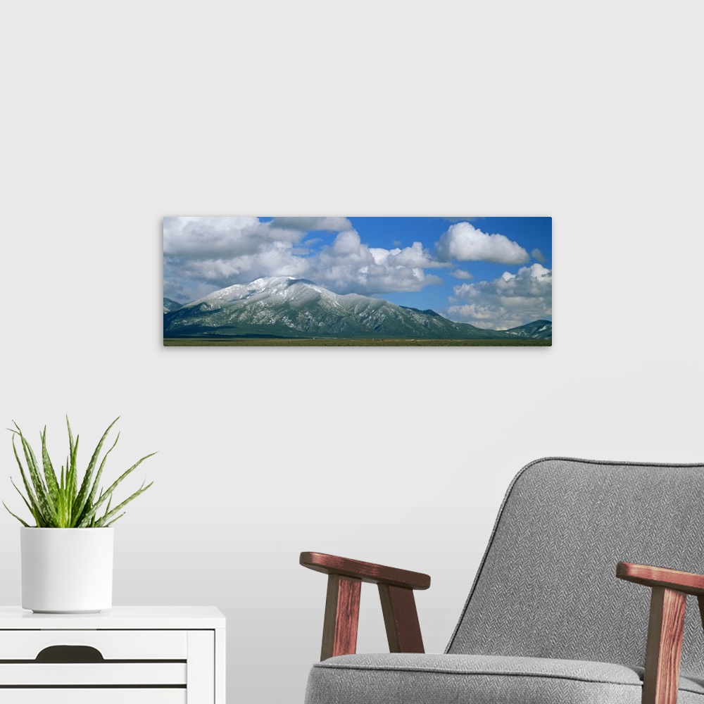 A modern room featuring Clouds over snowcapped mountains, Taos, New Mexico