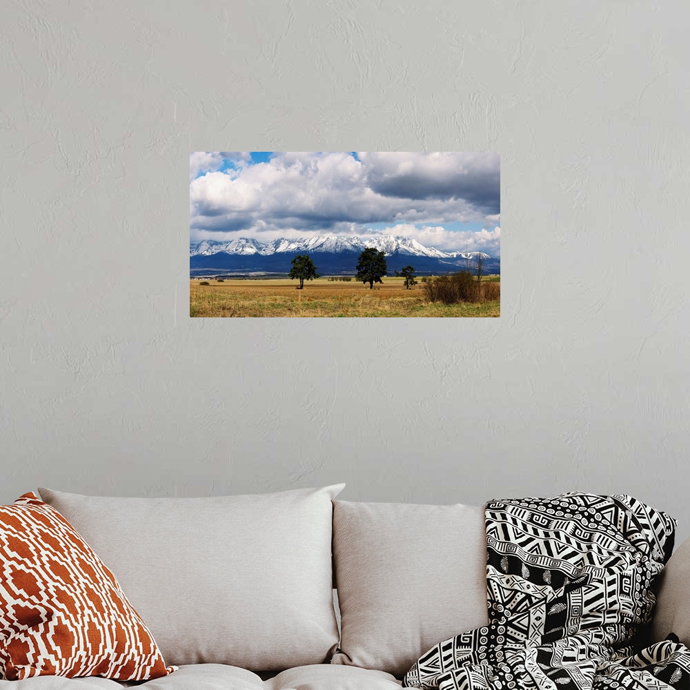 A bohemian room featuring Clouds over snowcapped mountains, Tatra Mountains, Slovakia
