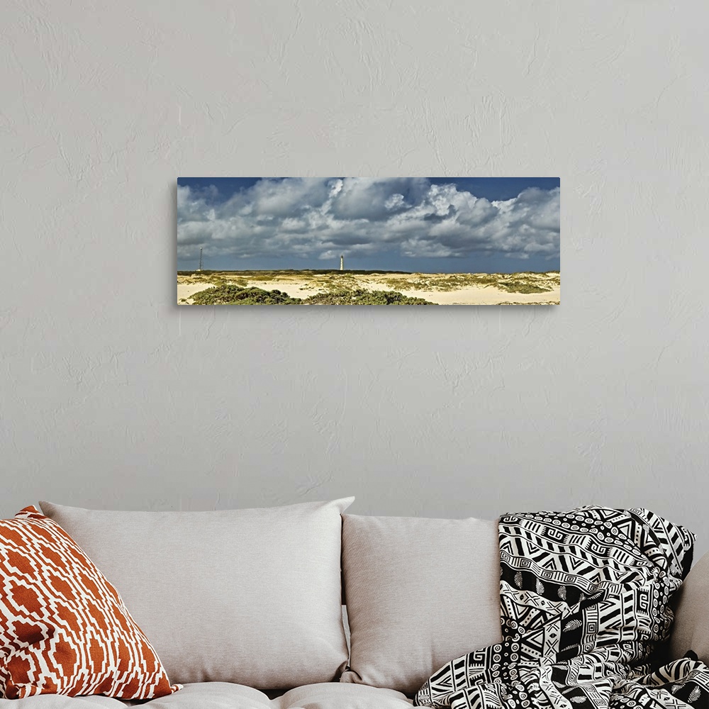 A bohemian room featuring Clouds over the beach with California Lighthouse in the background, Aruba