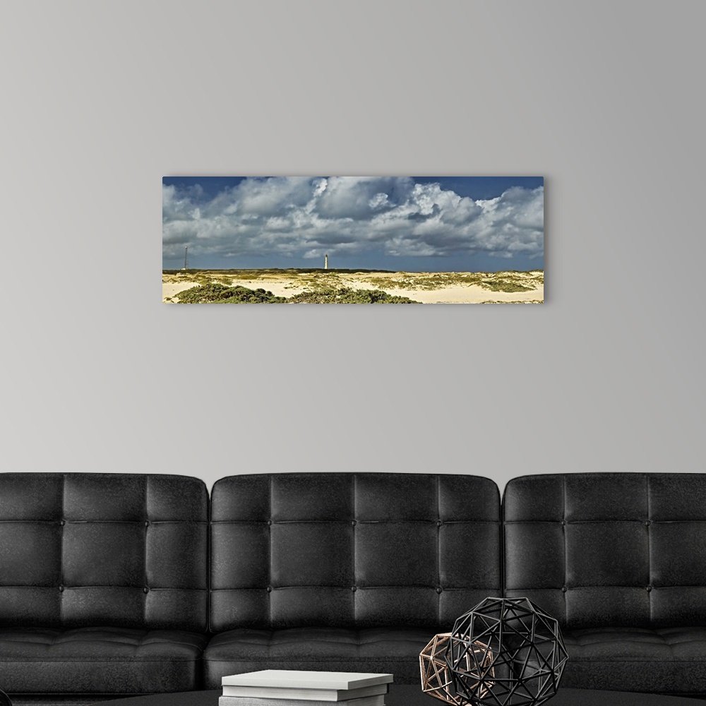 A modern room featuring Clouds over the beach with California Lighthouse in the background, Aruba