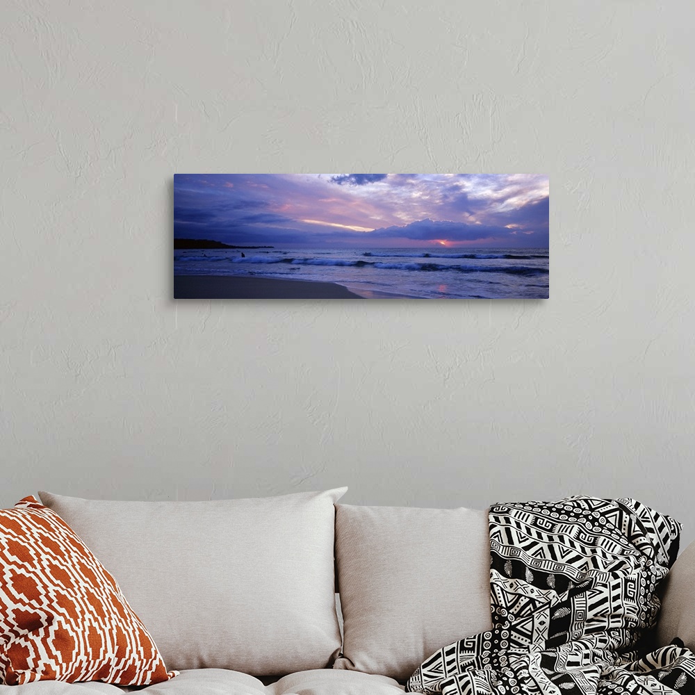 A bohemian room featuring This big picture is a panoramic photograph of the ocean surf sweeping over the shore. The sun fil...