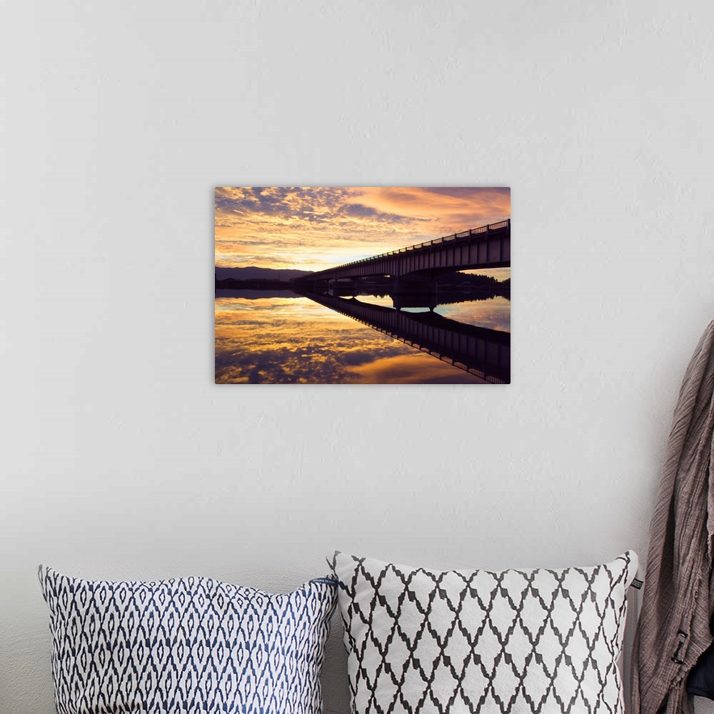 A bohemian room featuring Cloudy sunset sky over bridge, reflection in Flathead River, Montana