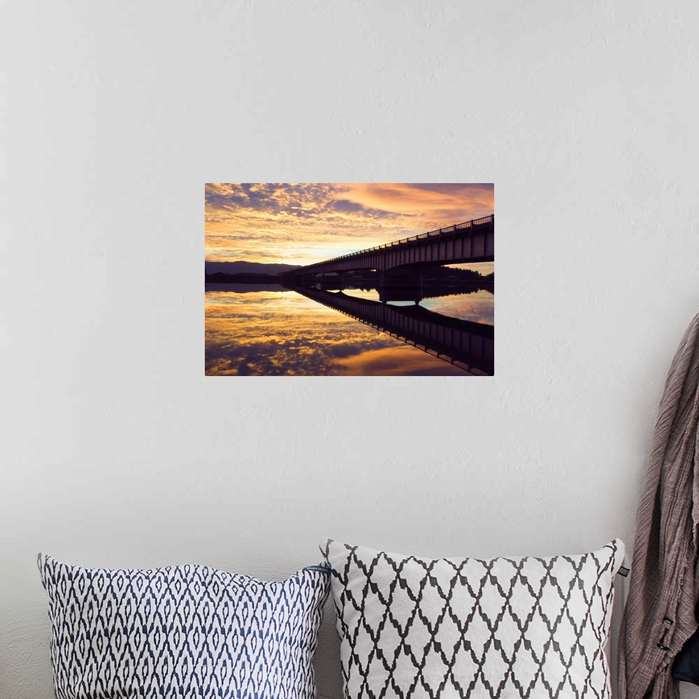 A bohemian room featuring Cloudy sunset sky over bridge, reflection in Flathead River, Montana