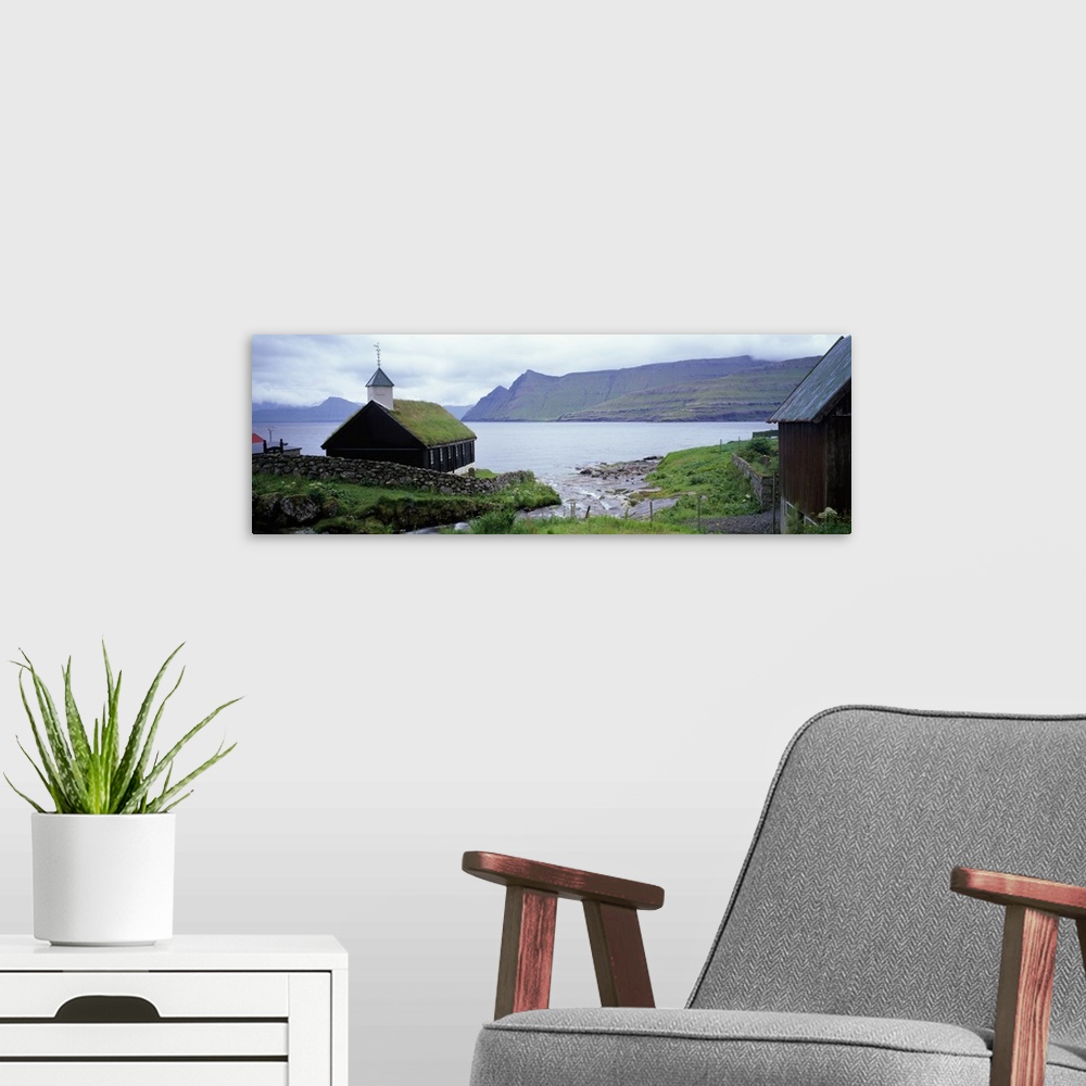A modern room featuring Coastal church with grass roof, Faroe Islands