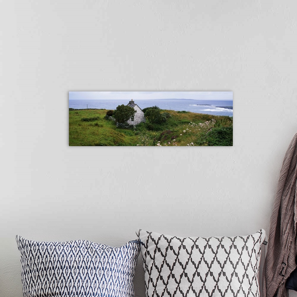 A bohemian room featuring Coastal landscape with white stone house, Galway Bay, The Burren region, Ireland