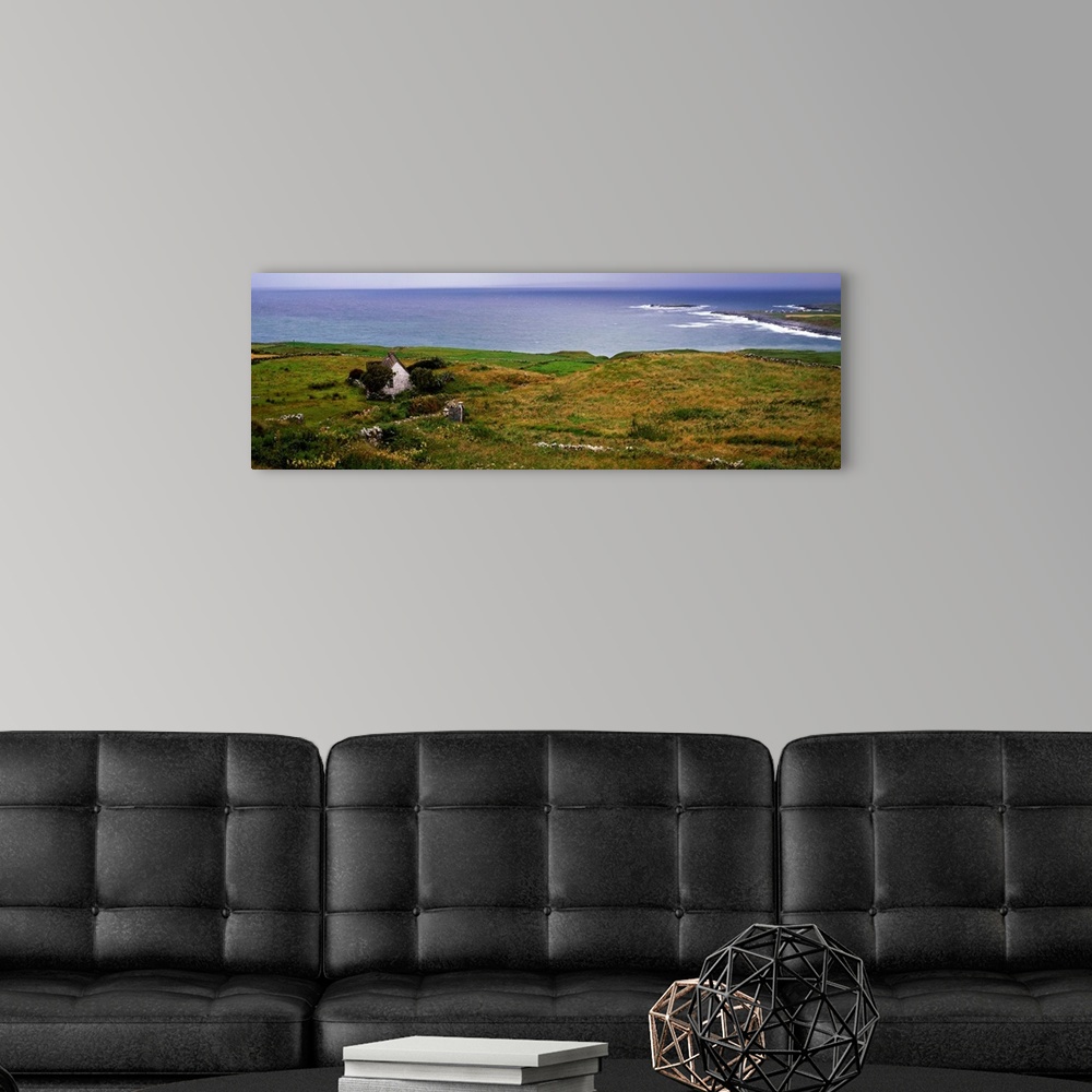 A modern room featuring Coastal landscape with white stone house, Galway Bay, The Burren region, Ireland