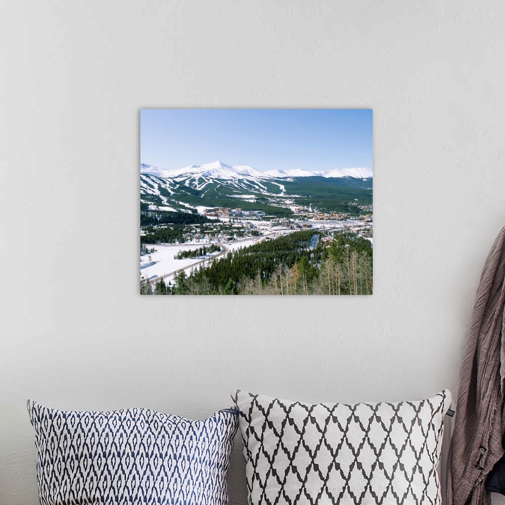 A bohemian room featuring Photograph of aerial view of city that is covered in snow with mountains in the distance and fore...