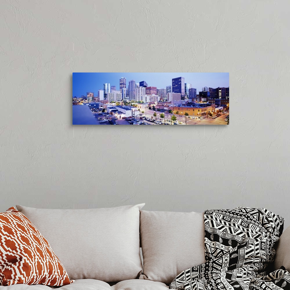 A bohemian room featuring Panoramic view of a vibrant downtown Denver on canvas.