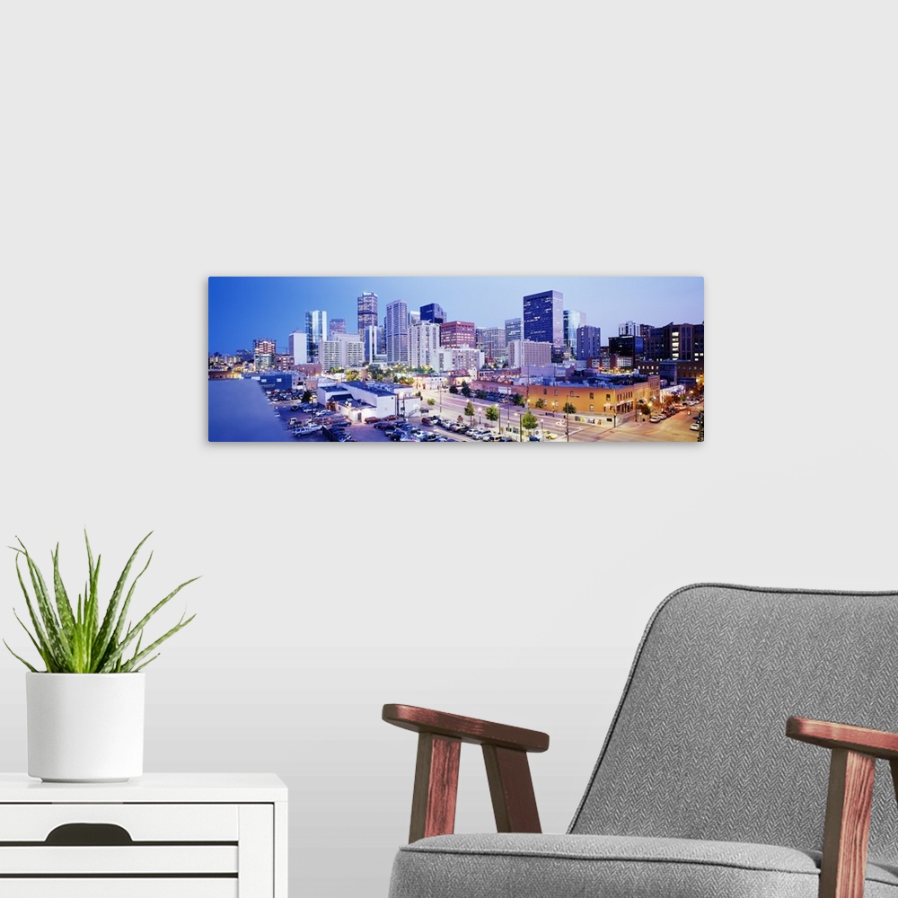 A modern room featuring Panoramic view of a vibrant downtown Denver on canvas.