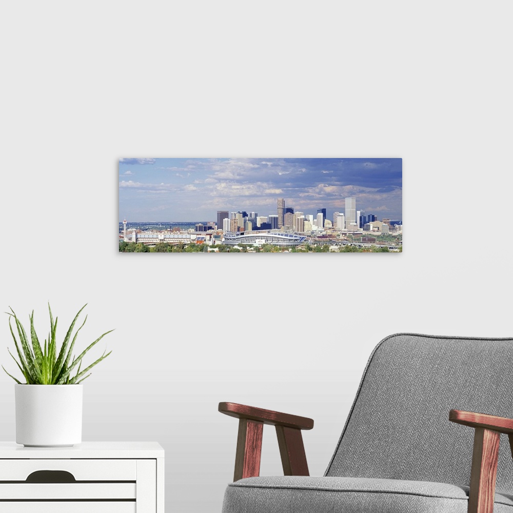 A modern room featuring Panoramic view of clouds approaching Denver, CO's Invesco Stadium.