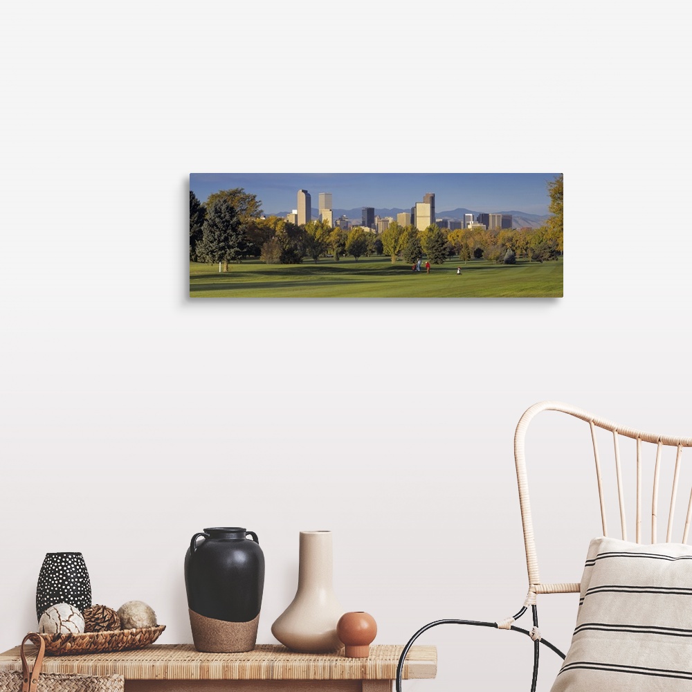 A farmhouse room featuring Big, panoramic photograph on the green of a golf course in Colorado, full of trees, the buildings...