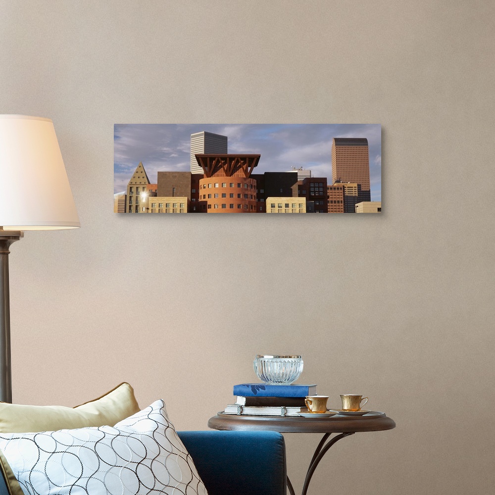 A traditional room featuring Big, horizontal, close up photograph of the tops of skyscrapers in Denver, Colorado, against a mo...