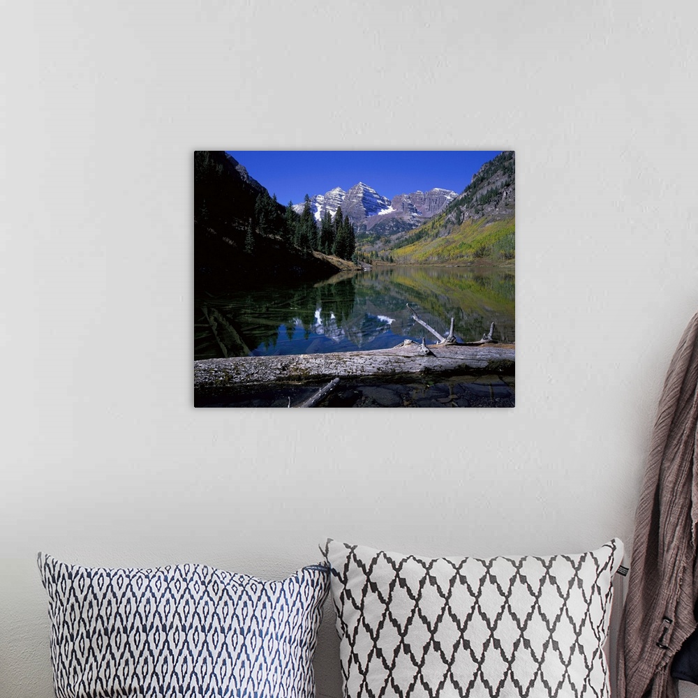 A bohemian room featuring Giant photograph of Maroon Bells, Colorado (CO) on a sunny day with a fallen tree trunk and lake ...