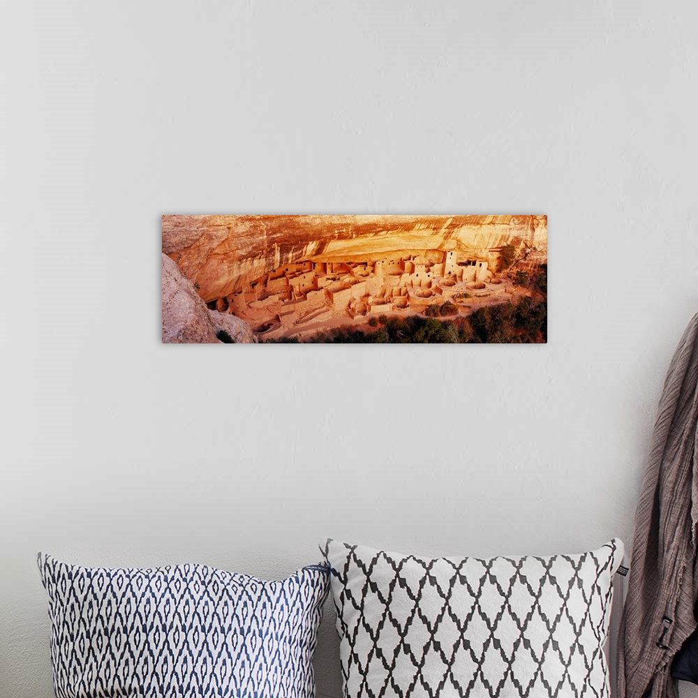 A bohemian room featuring This panoramic vista looks down into the cliff dwellings of the ancient Pueblo people as the ston...