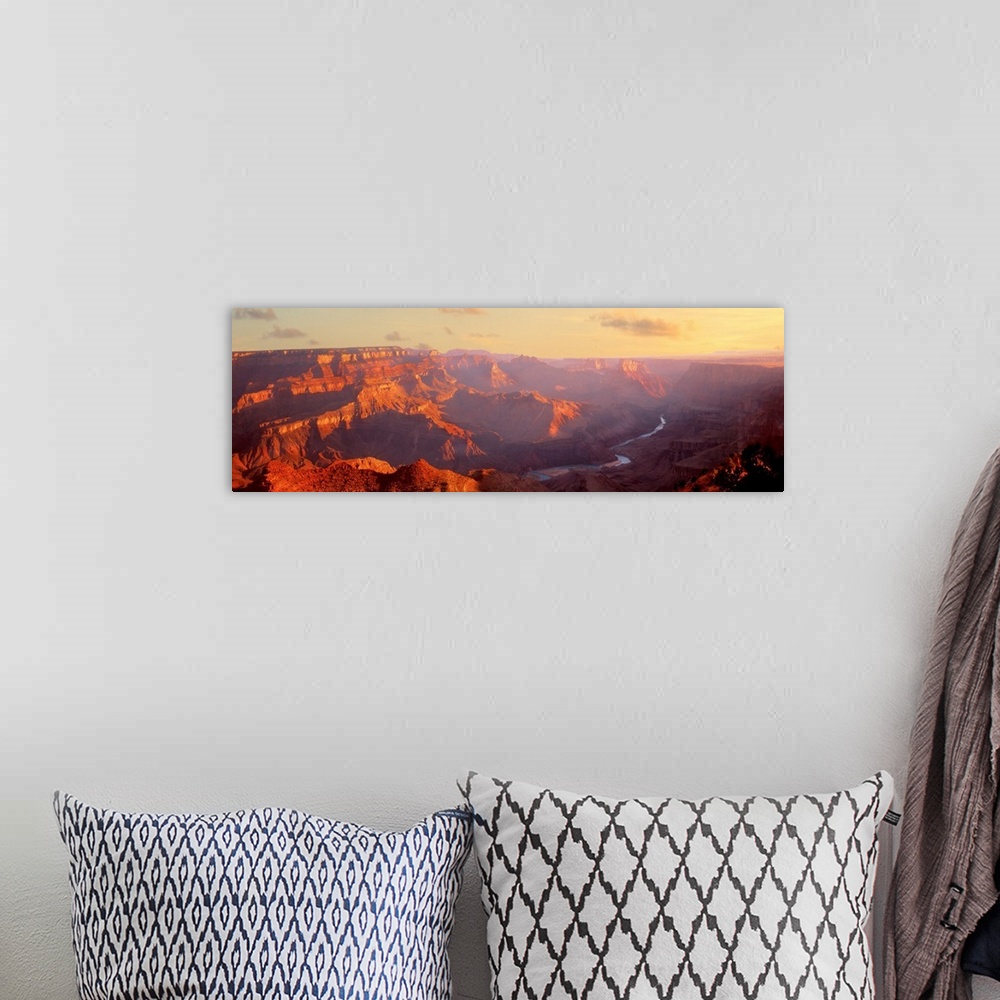 A bohemian room featuring Panoramic photograph of gorge with a stream running through the base.  There is fog with only a f...
