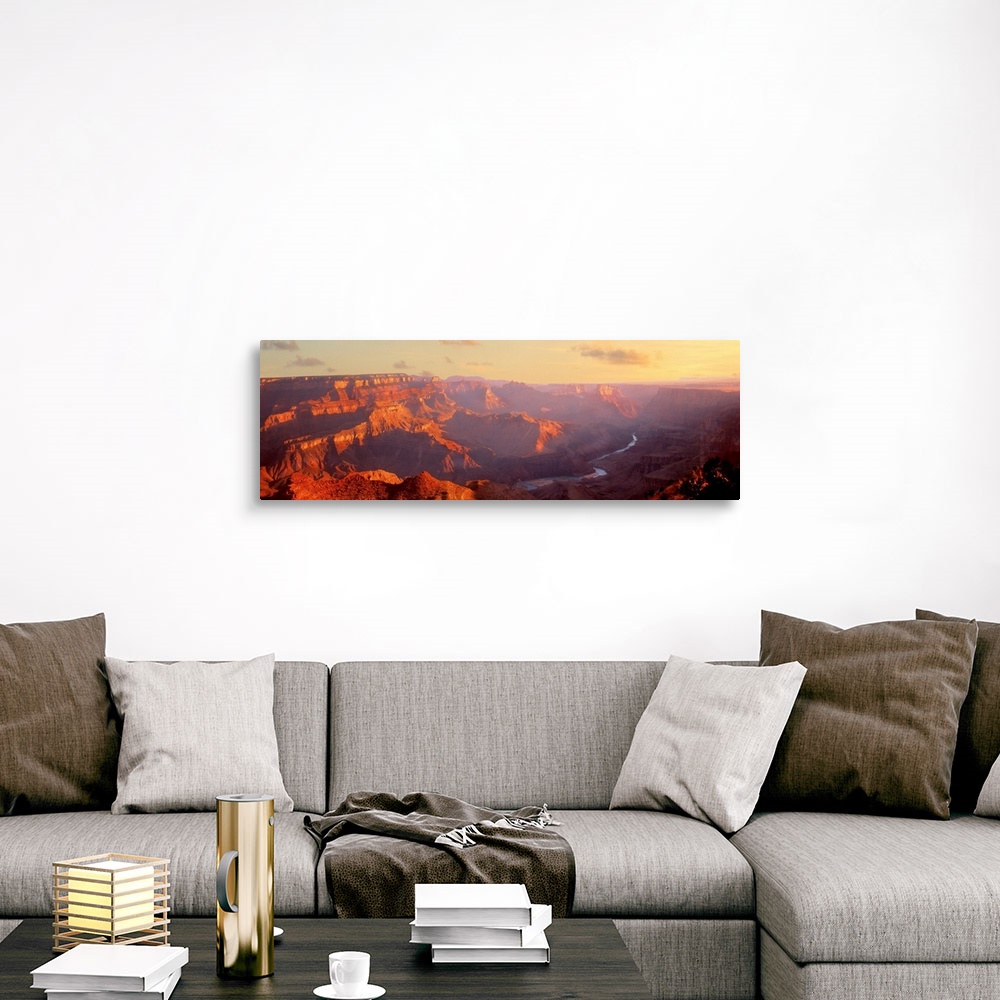 A traditional room featuring Panoramic photograph of gorge with a stream running through the base.  There is fog with only a f...