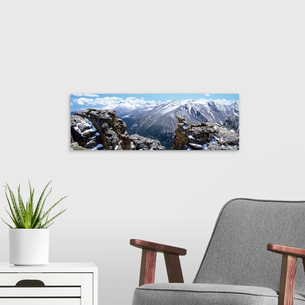 A modern room featuring Huge panoramic photograph of the Rocky Mountain National Park in Colorado (CO) on a sunny day. Sn...