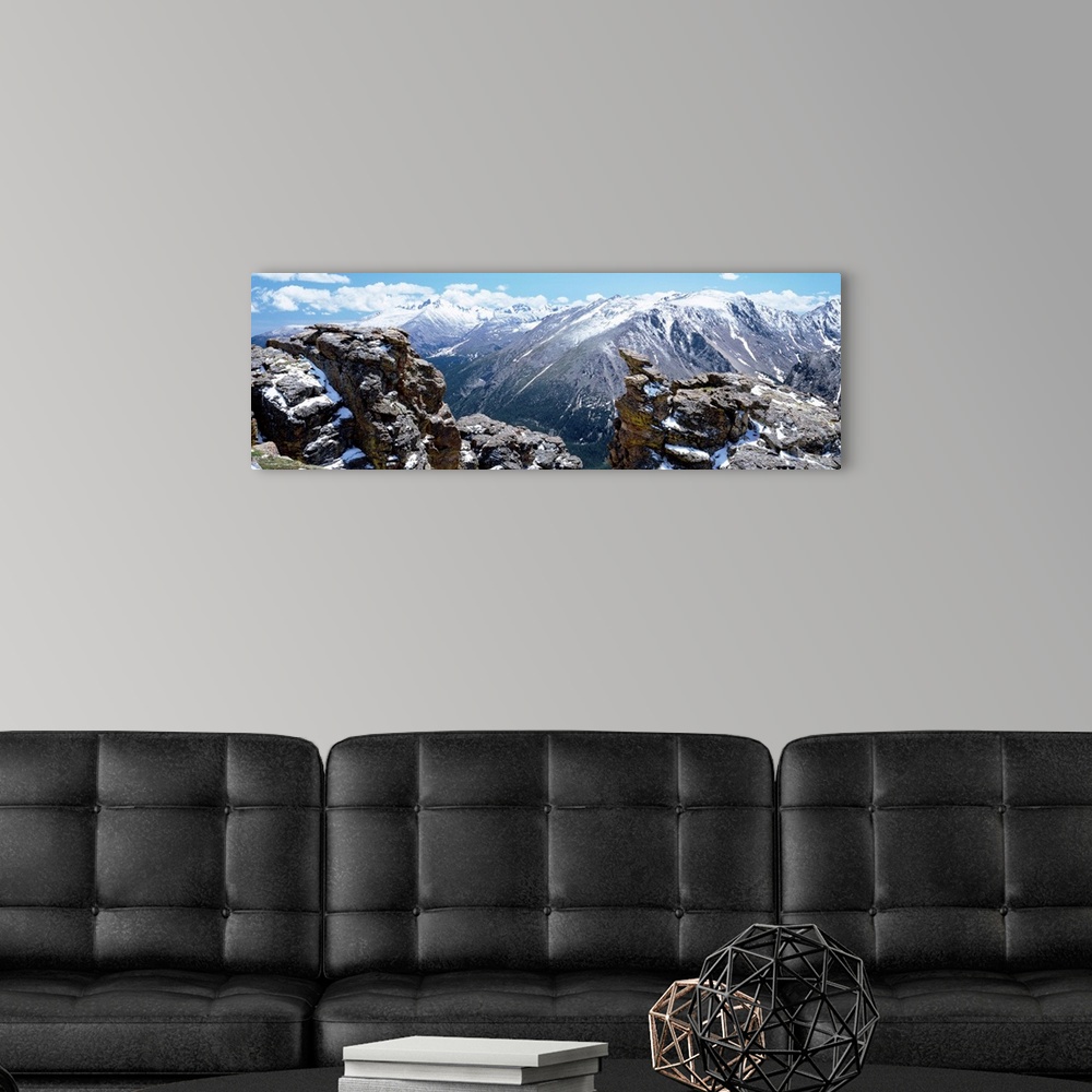 A modern room featuring Huge panoramic photograph of the Rocky Mountain National Park in Colorado (CO) on a sunny day. Sn...