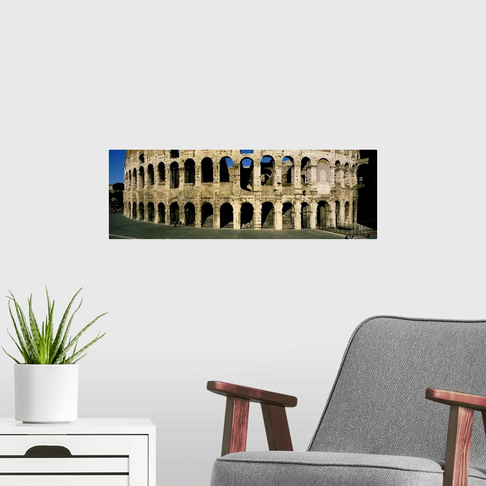 A modern room featuring Panorama of the Roman Colosseum with detail of the arches.
