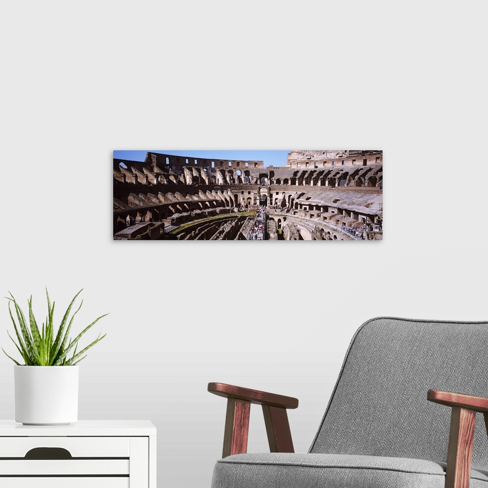 A modern room featuring Wide angle picture taken inside the infamous coliseum in Rome.